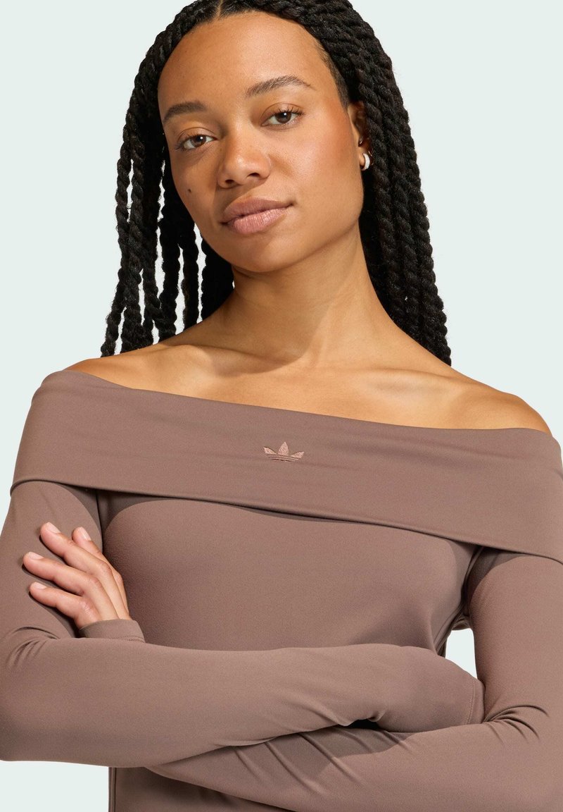 Top marrone off-shoulder in materiale elasticizzato con maniche lunghe. Presenta un piccolo logo ricamato sul petto. Tessuto liscio.
