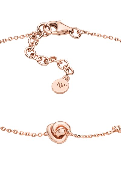 Rose gold-armbånd med kædedesign, lukning med spænde og en knudedetalje som et fokalt element. Glat tekstur med en poleret finish.