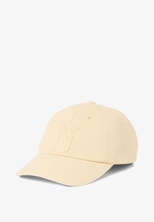 Beige baseball cap with curved brim and embroidered "N" on front panel, made of textured fabric.