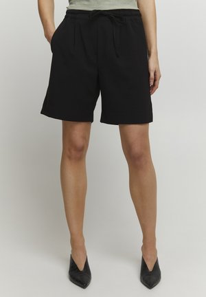 Zwarte shorts met een elastische tailleband, trekkoorddetail en zijzakken. Gemaakt van een zachte stof met een relaxte pasvorm.