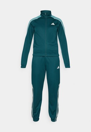 Turquoisekleurig trainingspak van gladde stof, met een ritsjack met hoge kraag en witte streepjes op de mouwen en broeken, met logo-accenten.