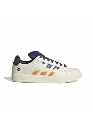 Scarpa da ginnastica Adidas bianca con strisce fiamme arancioni e blu, tacco nero, linguetta viola e lacci neri su sfondo bianco piatto.