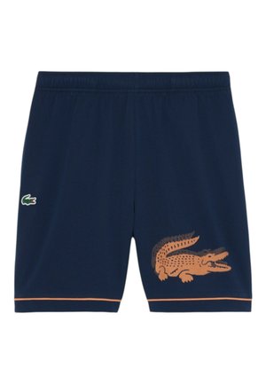Pantaloncini blu navy con fascia elastica in vita, piccolo logo di coccodrillo verde sul lato sinistro, grande grafica di coccodrillo arancione sulla gamba destra e rifinitura arancione all'orlo.