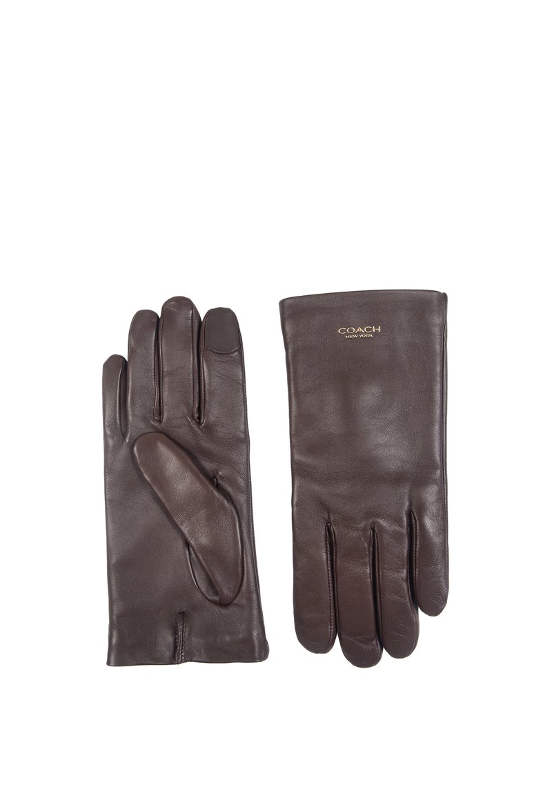 Guanti in pelle marrone con una texture liscia, dotati di cinque dita e un polsino leggermente più lungo. Logo Coach impresso sul polsino.