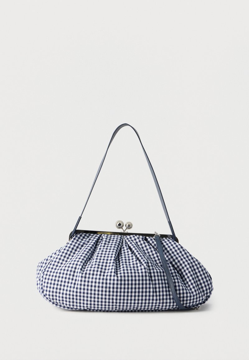 Small navy and white gingham fabric purse with a gathered design, silver clasp, and a single shoulder strap.