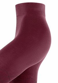 Calza fino bordeaux al ginocchio con bordo a costine, texture liscia e motivi a rombi neri in contrasto sulla parte inferiore.