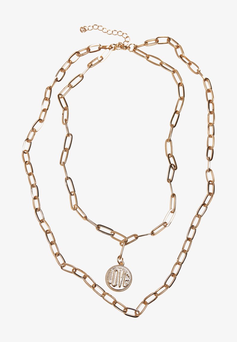 Kuldtooneline kaheetapiline kaelakee, millel on ühendatud kettide ja ümmargune ripats, millel on graveeritud "ARMASTUS". Kettide silmad on pikendatud ja poleeritud.