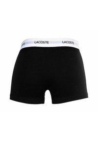 Czarne bawełniane szorty bokserskie z białym elastycznym pasem w logo Lacoste. Gładka tekstura i dopasowany krój.
