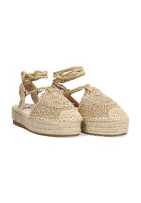Sandalias de espadrille beige con textura trenzada, punta redonda y lazos en el tobillo. Suela de plataforma hecha de yute trenzado, que ofrece altura adicional.
