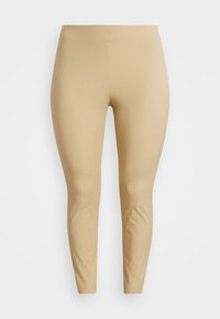 Beige leggings valmistettu joustavasta, sileästä kankaasta, joka on tiukasti istuva ja kapeneva nilkassa, ilman näkyviä saumoja tai metallidetaljeja.