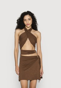Vestido de tecido leve e castanho com um design de halter, recortes laterais e detalhes de envolvê-lo seguros com ferragens decorativas.