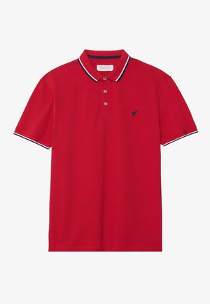 Red polo shirt with a textured finish, contrasting navy blue collar and sleeve accents, and a small embroidered logo on the chest.