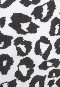 Black leopard spots on a white textured fabric, featuring irregular shapes and varying sizes of the patterns throughout.
