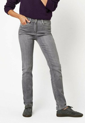 Gray denim jeans with a slim fit, five-pocket design, and subtle fading. Paired with gray sneakers, displayed against a neutral background.