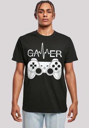Black cotton T-shirt featuring a white graphic of a game controller and the text "GAMER" above, with a heartbeat line integrated in the design.