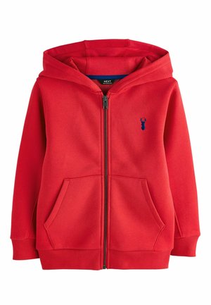 Červená mikina na zips s prednými vreckami, rebrovanými manžetami a malým tmavomodrým jeleňom na ľavej strane hrudníka.