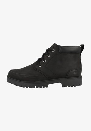Schwarze Leder-Stiefeletten mit abgerundeter Zehenform, genähten Details und einer Gummisohle für besseren Halt. Vier Metallösen für die Schnürsenkel.