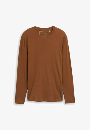 T-shirt à manches longues, marron, avec un col rond, fabriqué en tissu doux. Il dispose d'une étiquette à l'intérieur du col et d'une coupe droite au niveau de l'ourlet.