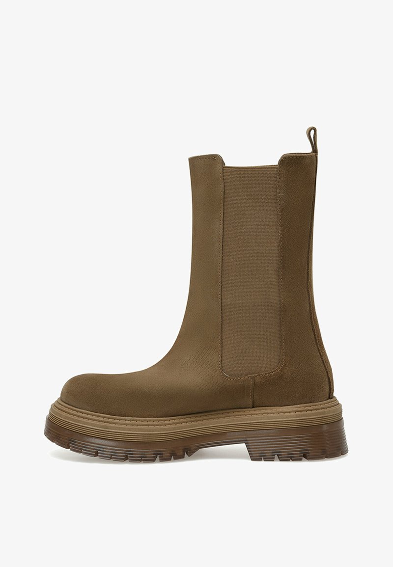 Botines marrones con paneles laterales elásticos, parte superior de ante texturizado y sintético, y una suela de goma gruesa y estriada.