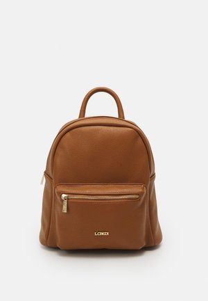 Brown leather backpack with a rounded shape, textured surface, and a front zip pocket. Features a top handle and gold-tone brand logo.