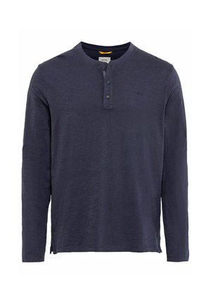 Marineblå langærmet skjorte med henley-udskæring, tre knapper, tekstureret stof og sideslidser for en afslappet pasform. Lacoste-logo på brystet.