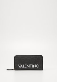 Black wallet with a textured surface, featuring a bold white "VALENTINO" logo and subtle repeating pattern. Zippered closure and leather accents.