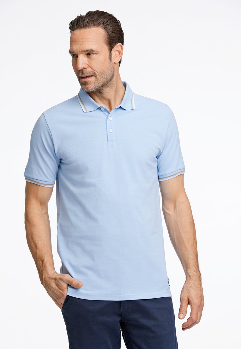 Polo de color azul claro hecho de algodón, con un cuello clásico, tapeta de tres botones y acentos a rayas en el cuello y las mangas.