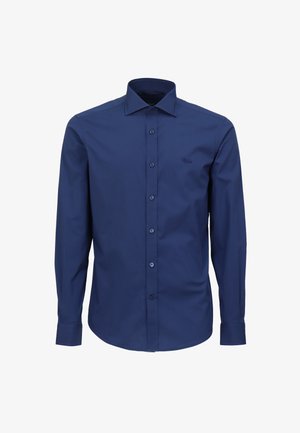 Camicia a maniche lunghe blu navy realizzata in tessuto liscio, con colletto classico e chiusura frontale con bottoni. Piccolo logo sul petto.