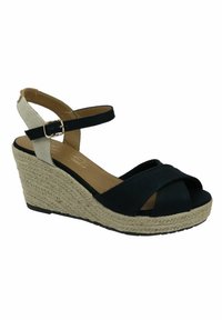 Black fabric wedge sandal with crisscross front straps, beige woven heel, and black adjustable ankle strap with gold buckle.