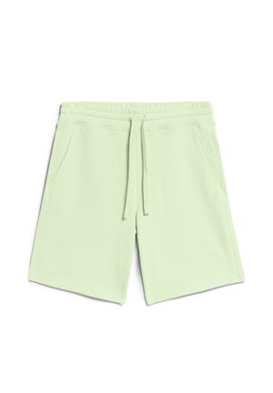 Lichtgroene sportieve shorts gemaakt van zacht materiaal, met een elastische tailleband met trekkoord en twee zijzakken. Eenvoudig ontwerp zonder patronen.
