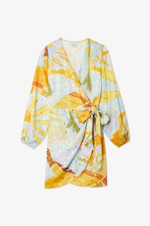 Langarm wikkeljurk met een kleurrijke tropische print en gouden stippen, gestrikt in de taille, die een lichte, luchtige uitstraling heeft.