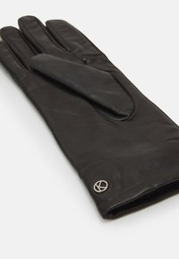 Black leather glove with a smooth texture, featuring a fold-over design and a circular silver logo near the cuff.