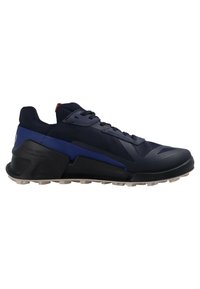 Low-cut navy and black athletic shoe with lace-up front, breathable mesh upper, thick sole with tread, and blue accent on heel and side.