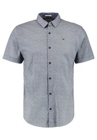 Camicia a maniche corte con bottoni di colore azzurro chiaro, con un sottile motivo a griglia, realizzata in tessuto a trama, con un piccolo logo sul petto.
