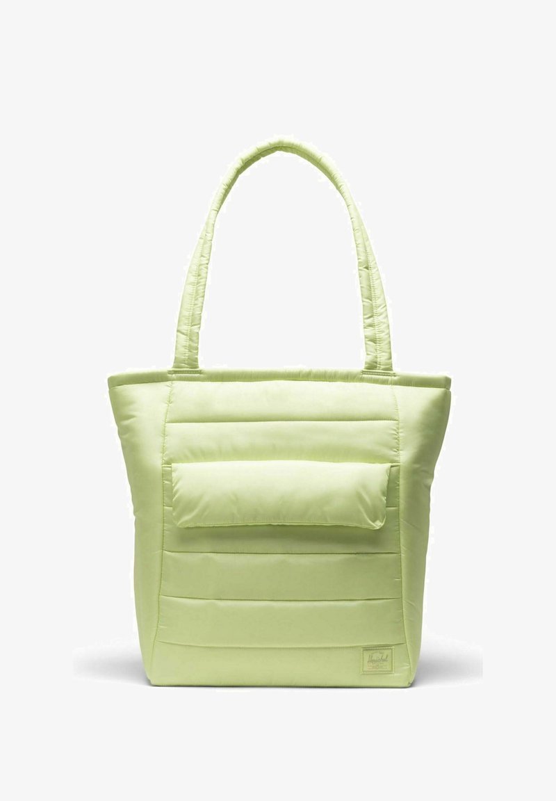Sac cabas matelassé vert clair avec de longues anses, doté d'une poche avant et d'une texture lisse et douce. Lignes de couture visibles sur le corps.