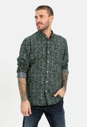 Button-up shirt in navy with a floral pattern in green and yellow. Features a classic collar, long sleeves, and a part-button placket.