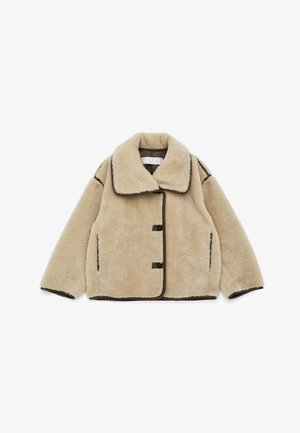 Beige faux fur jacket with a wide collar, brown trim, and three front buttons. Features two side pockets and a boxy silhouette.
