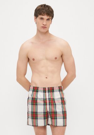 Herre badeshorts med rutete mønster i flere farger, inkludert rødt, grønt, blått og hvitt. Elastisk midjebånd, sidelommer.