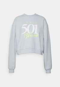 Sweat-shirt court bleu clair à manches longues avec le texte "Levi's 501 Blues" en blanc et jaune sur le devant.