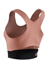 Brasile sportivo rosa chiaro con design a racerback, texture liscia, fascia elastica nera nella parte inferiore e dettaglio del logo di lato.