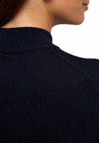 Navyblauer Strickoberteil mit hohem Kragen, ausgestattet mit einer gerippten Textur und Schulternähten. Glattes Gewebe mit enganliegendem Design.