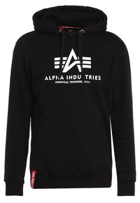 Czarna bluza z kapturem, wykonana z mieszanki bawełny, z przednią kieszenią, kapturem ze sznurkiem i dużym białym logo z napisem "Alpha Industries". Czerwony akcent na metce.