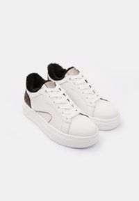 White leather sneakers with a black fur-lined collar, gray accents, and a leopard print detail on the heel. Flat white rubber sole.
