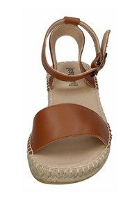 Brown leather sandal with an open toe, ankle strap, and woven jute sole. Features a smooth, matte finish and adjustable buckle.