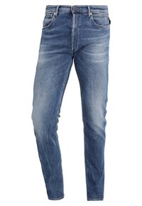 Vaaleansiniset farkut, slim fit -mallia, joissa on hieman kulutusta ja haalistuneita alueita. Farkuissa on viisi taskua sekä vetskari ja nappisuljenta.