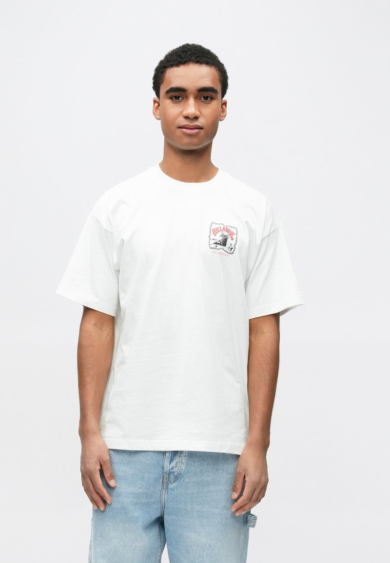 Λευκό βαμβακερό t-shirt με κοντά μανίκια. Διαθέτει γραφικό σχέδιο στο αριστερό μέρος του στήθους σε κόκκινο και μαύρο χρώμα. Άνετη εφαρμογή.