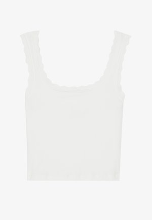 Bílý žebrovaný top bez rukávů s vlnitými okraji na ramínkách a výstřihu, s přiléhavým střihem a měkkou texturou.