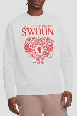 Man wearing white sweatshirt with red text "An expert in the art of the SWOON" above an ornate heart design featuring a silhouette cameo.