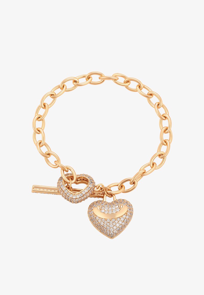 Arany lánc karkötő szív alakú záródással és szív alakú charm-mal, amelyet apró, tiszta drágakövek díszítenek.