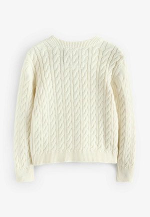 Kabelstickad tröja i off-white. Har ribbade muddar och nederkant, med ett strukturerat mönster genom hela. Klassisk design med rund hals.